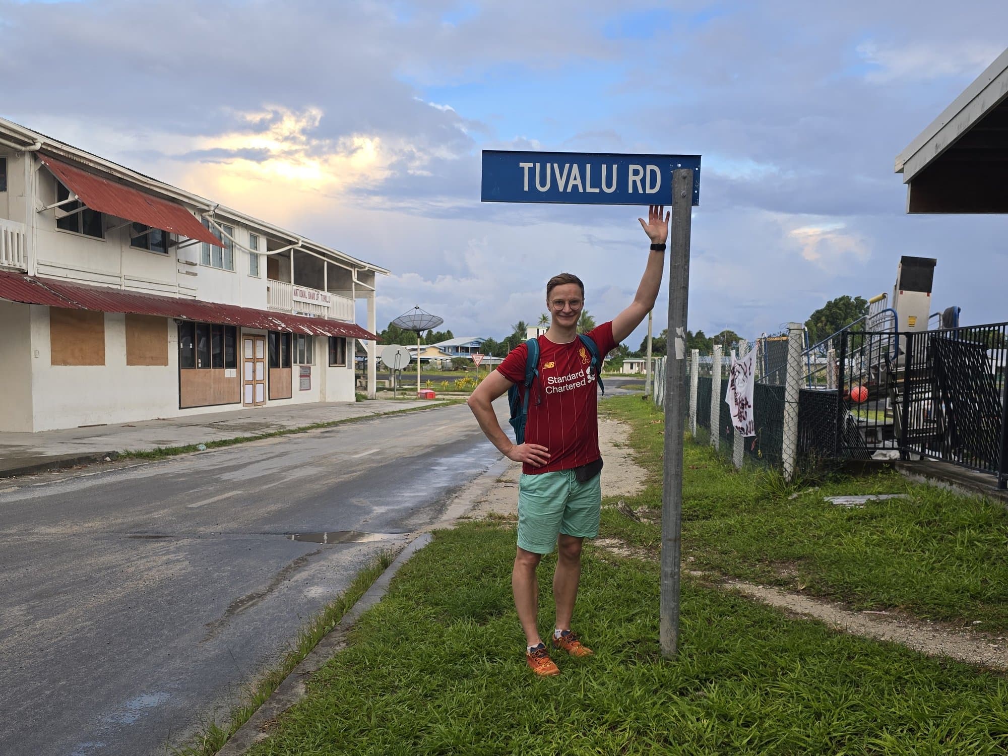 Standing at the TUVALU RD street sign in Vaiaku at dusk